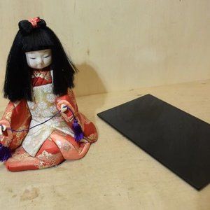 Japanese Girl Doll In Red Kimono Sitting Down With